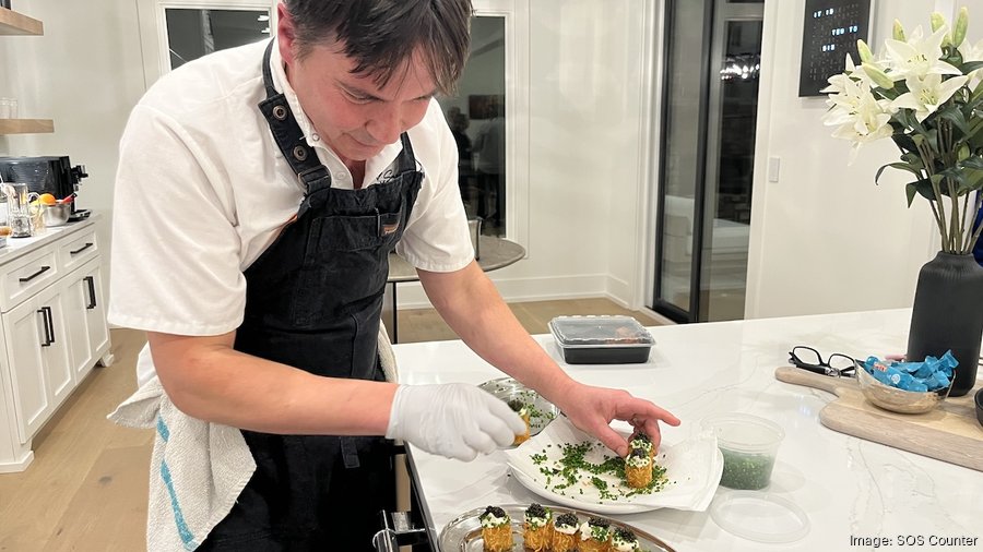 An SOS Counter chef carefully plating food in the kitchen